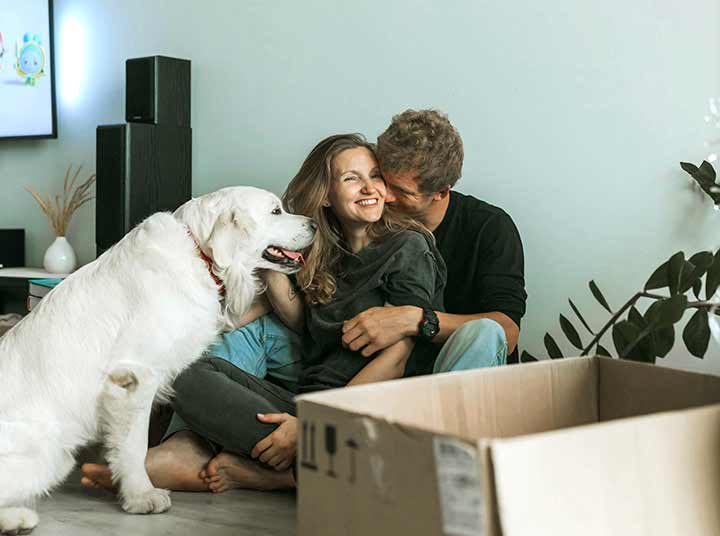 Young couple with dog that just moved