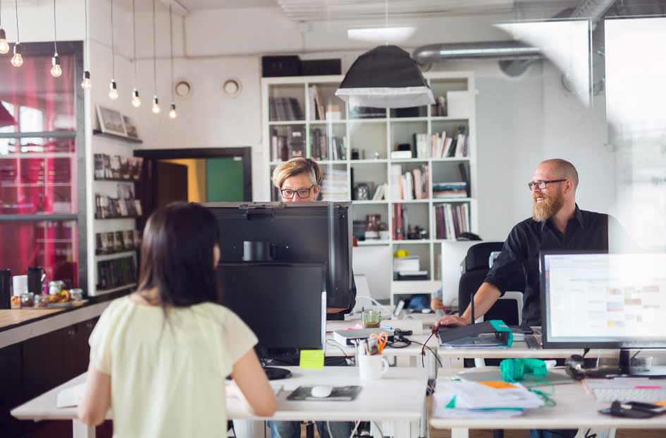 3 people working in a small office